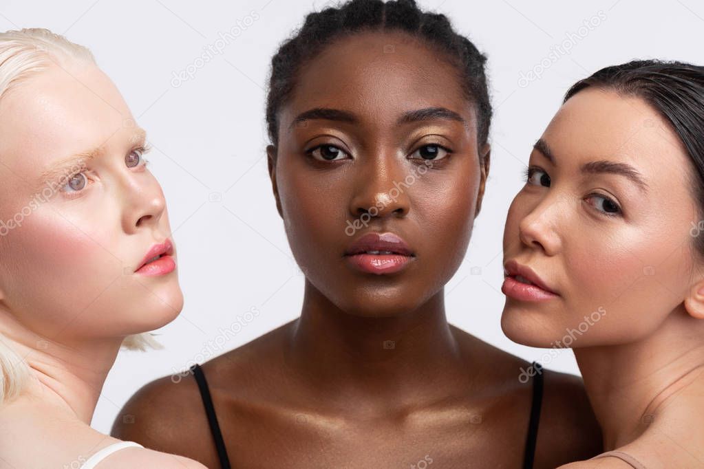 African-American woman standing between women with light skin