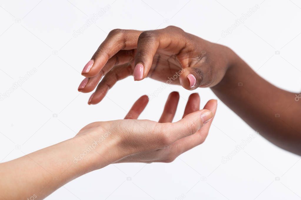 Women with different skin color posing using their hands