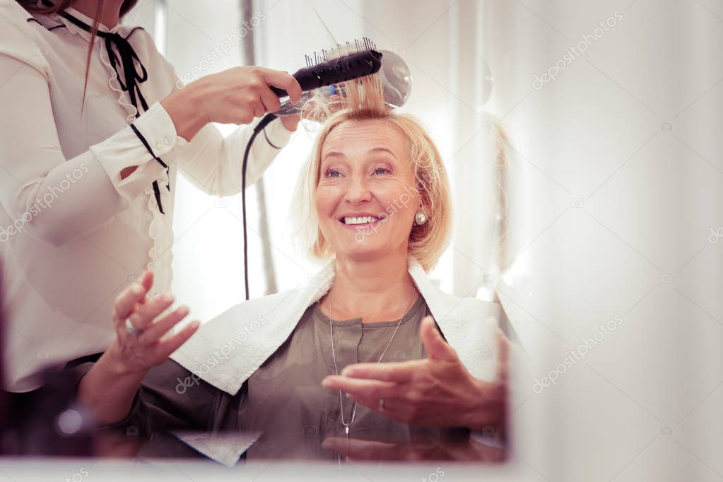 Cheerful elderly female communicating with her master