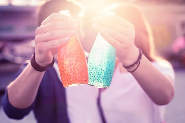 Young couple standing in bright lights of fading sun — 스톡 사진