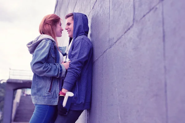 Passionate young couple having lovely moments while leaning on the wall — Stock Photo, Image