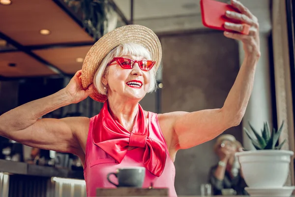 Delighted joyful aged woman posing for a selfie — Stock Photo, Image