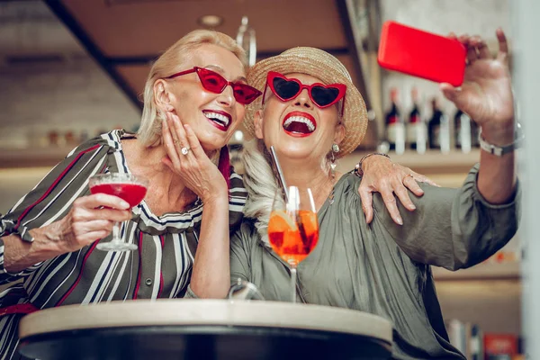 Позитивные счастливые женщины позируют для селфи — стоковое фото
