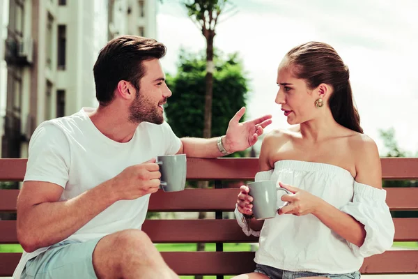 Positive delighted bearded man going to drink coffee — Stock Photo, Image