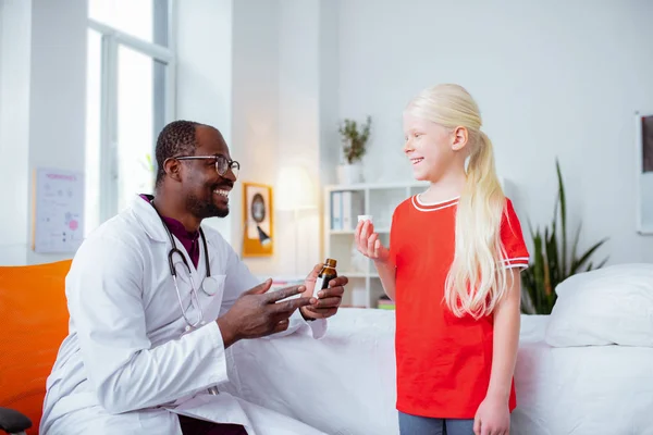 Blonde girl smiling while drinking cough syrup visiting pediatrician — Stock Photo, Image