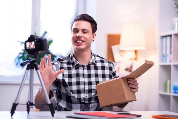 Smiling guy enjoying creation of video content