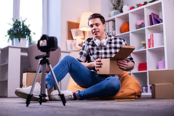 Zaměřený profesionální video blogger s otevřenou kartonovou krabicí — Stock fotografie