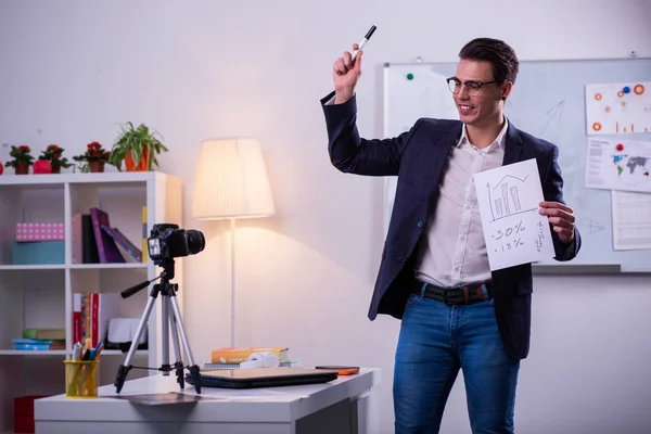 Smiling good-looking business expert actively gesturing and showing paper