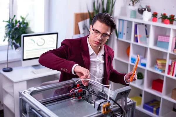 Interested serious scientist touching details of 3d-printer — Stock Photo, Image