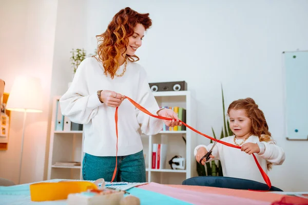 Young mother feeling amazing working in atelier with her daughter — Stock Photo, Image