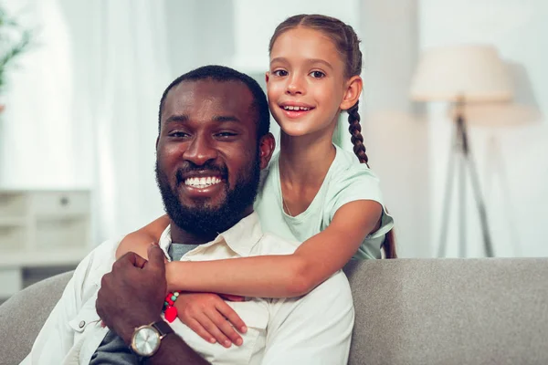Retrato facial de una hija pequeña abrazándose tiernamente riendo papá afroamericano —  Fotos de Stock