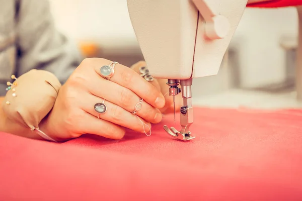 Hand of a designer in a process of sewing a dress. — Stock Photo, Image