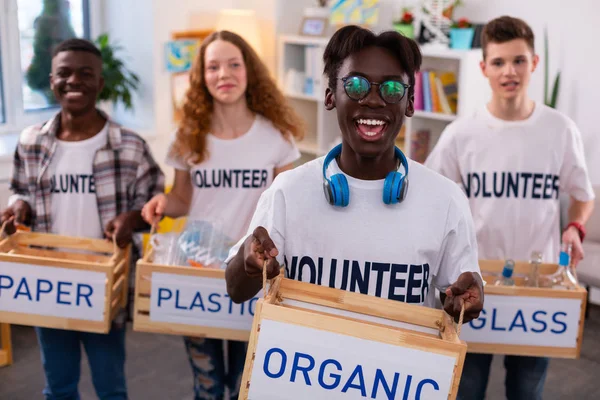 African-American teenager feeling satisfied after sorting waste — Stock Photo, Image