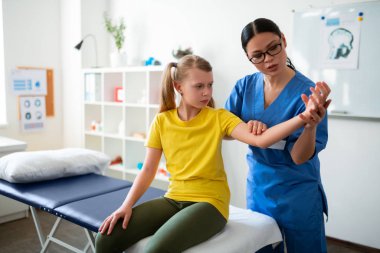 Ciddi koyu saçlı kadın profesyonel fizyoterapist olmak