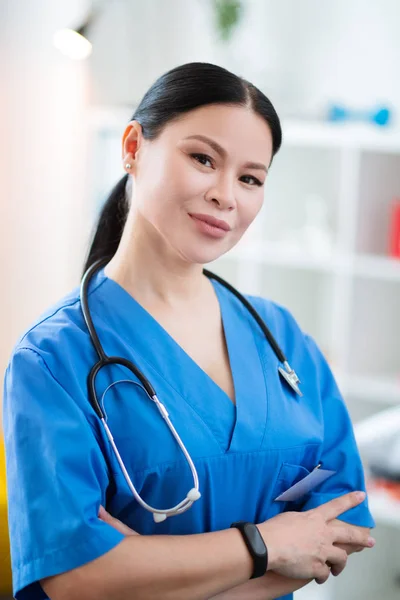 Pleasant long-haired therapist being in great mood while staying — Stock Photo, Image