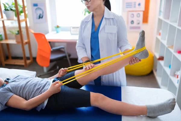 Hard-working little patient going through rehabilitation process — Stock Photo, Image