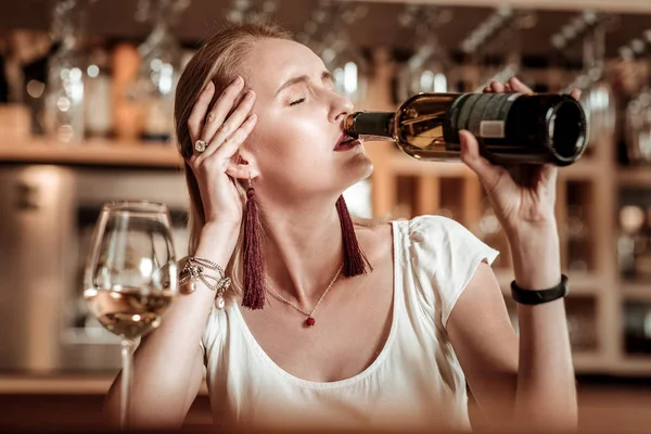 Perturbado jovem mulher bebendo vinho sozinho — Fotografia de Stock
