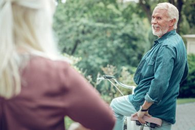 Memnun sakallı adam karısına dönüyor