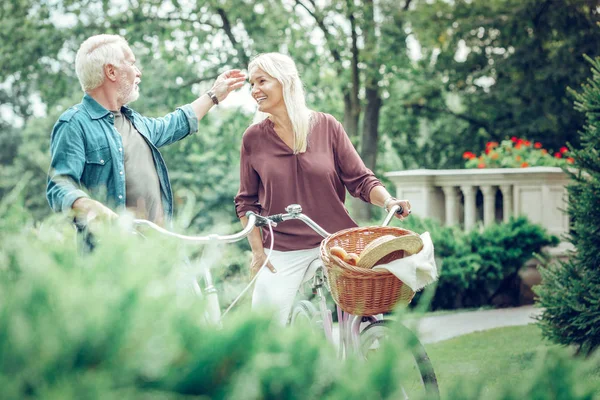 Fröhlicher netter Mann, der seine Frauen im Gesicht berührt — Stockfoto