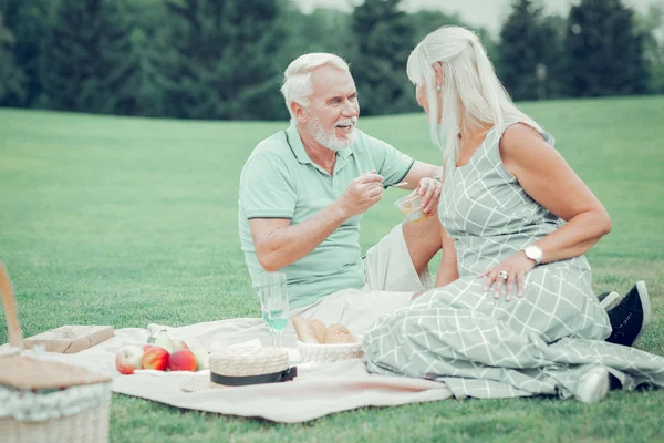 Casal idoso agradável desfrutando de seu piquenique romântico — Fotografia de Stock