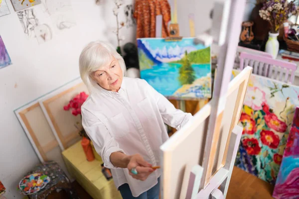 Vista superior de la famosa artista envejecida que trabaja en su taller —  Fotos de Stock