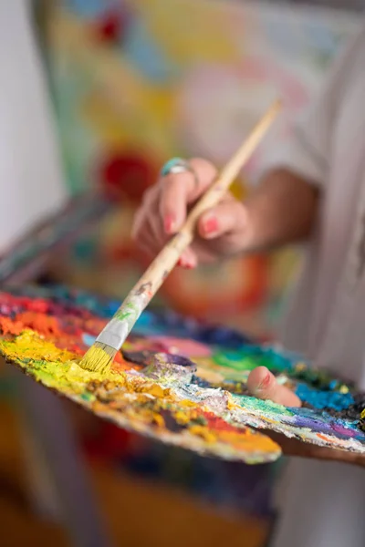 Primer plano de artista femenina con anillo sosteniendo pincel de pintura — Foto de Stock