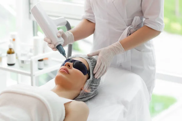 Pleasant pretty woman receiving special facial treatment — Stock Photo, Image