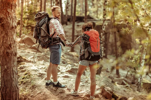 Positive nice couple going up the hill together — Stock Photo, Image