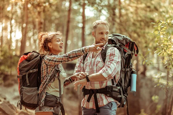 Joyful happy woman pointing with her hand — Stock Photo, Image