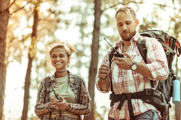 Delighted cheerful couple using special walkie talkies — Stock Photo, Image