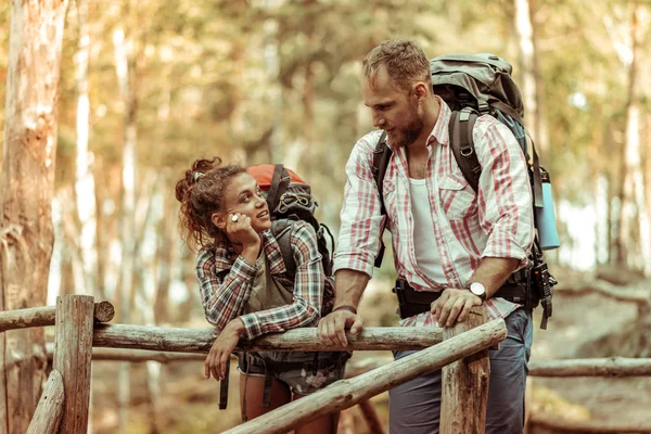 Cute active couple standing together on the wooden bridge — Stock Photo, Image