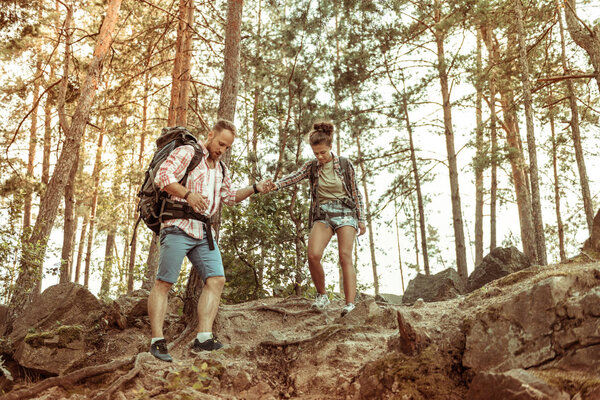 Nice pleasant young couple going down together