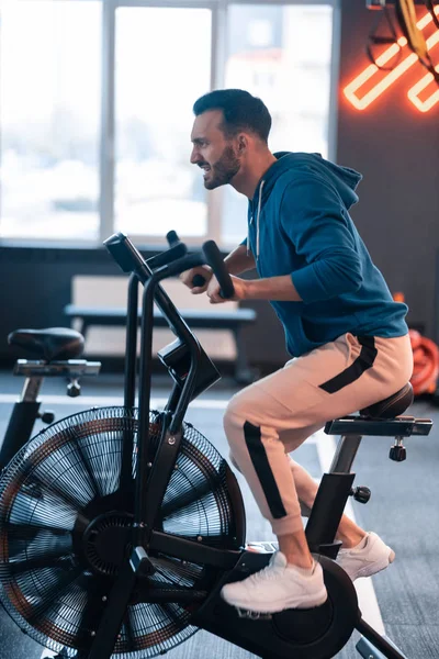 Athletic man feeling exhausted cycling for too long