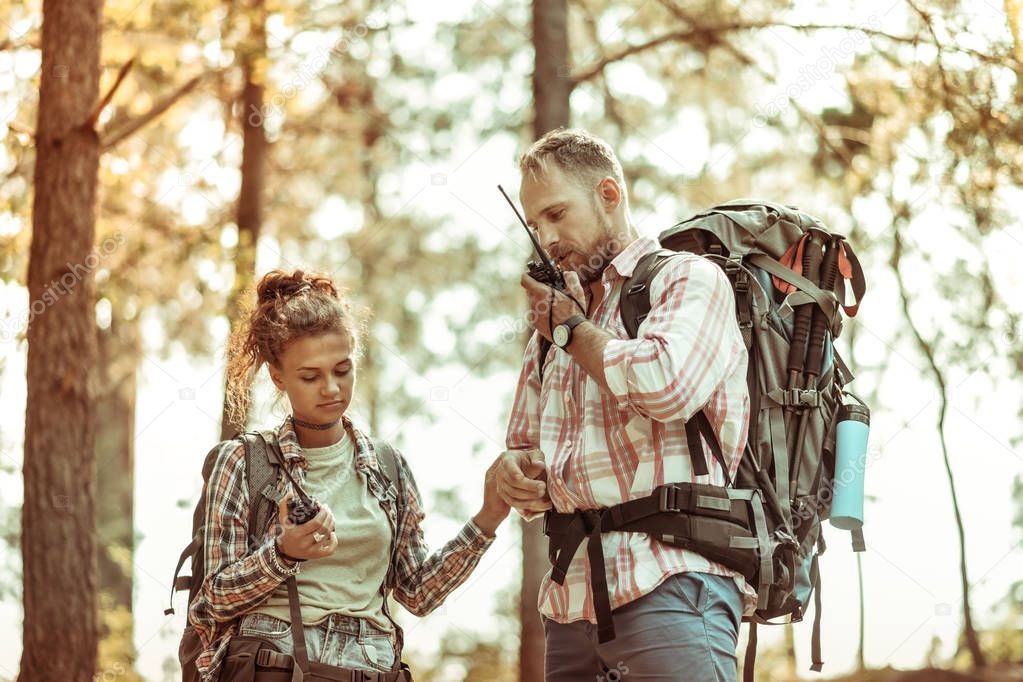 Nice young couple being lost in the forest