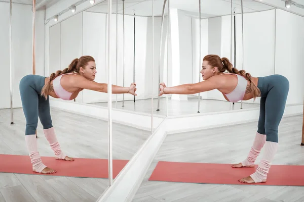 Mujer haciendo ejercicios deportivos frente al espejo . —  Fotos de Stock