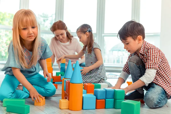 Nice pretty girl sitting neat the toy castle — Stock Photo, Image