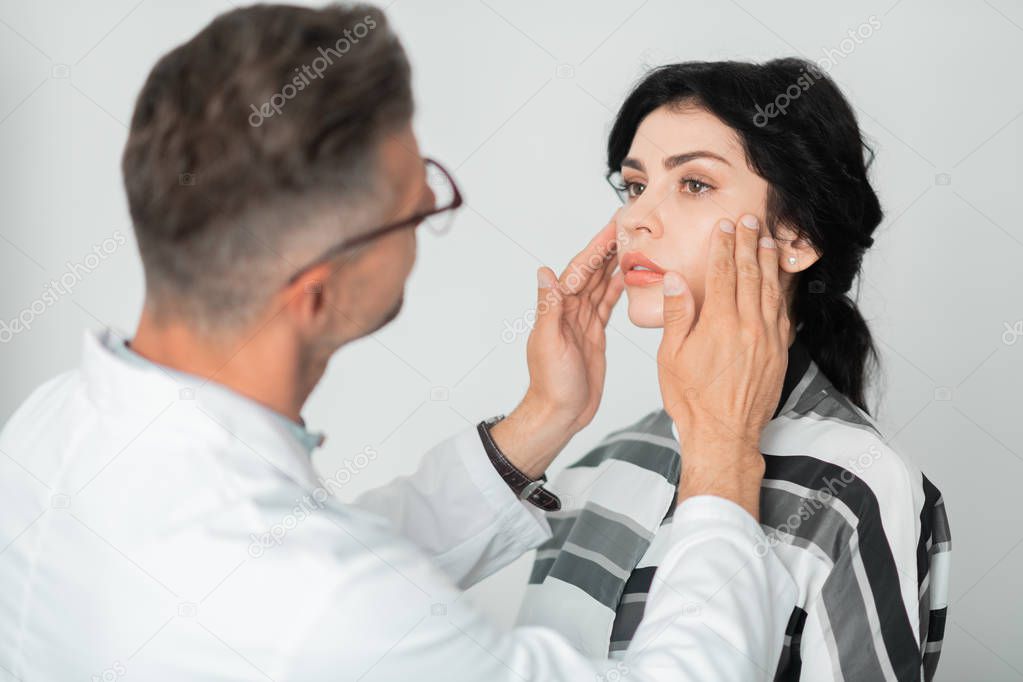 Woman having face measurements and examination before surgery
