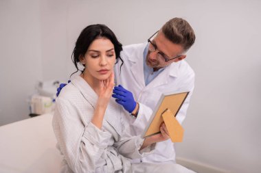 Anti-aging prosedürleri sonra aynaya bakan kadın