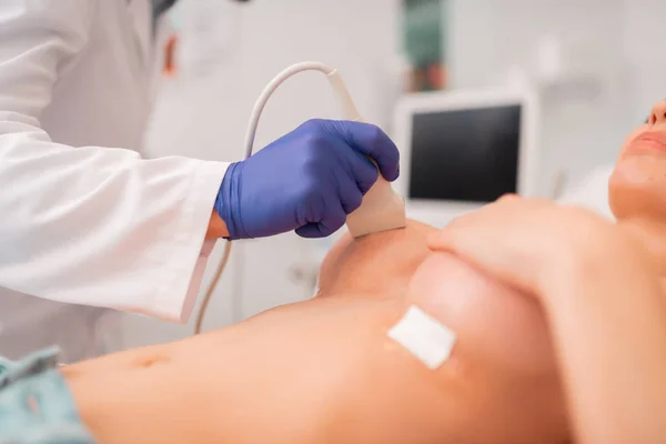 Close up of plastic surgeon making ultrasonography of breast — Stock Photo, Image