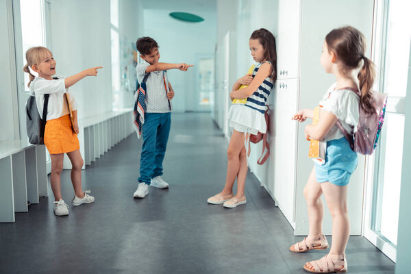 Rude children with bad behavior bullying their classmate