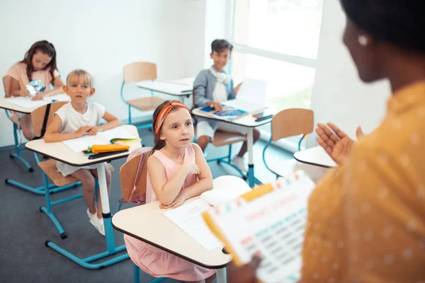 Attentive smart pupils listening to their professional teacher — Stock Photo, Image