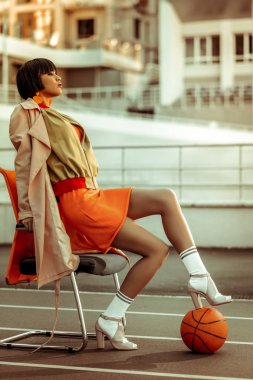 Sandalyede oturan çekici esmer kadın kişi