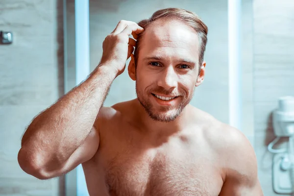 Красивый голый мужчина, смотрящий в зеркало — стоковое фото