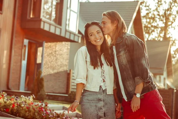 Pleasant loving man gently kissing his girlfriend while she being excited — Stock Photo, Image