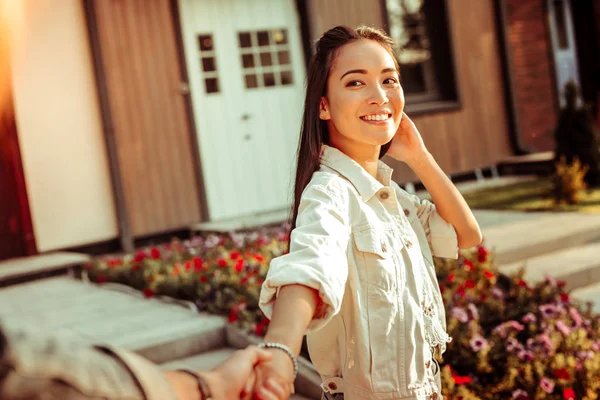 Cute smiling dark-haired girl in white jacket showing white teeth — Stock Photo, Image