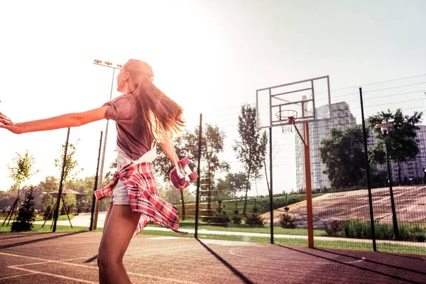 Dunkelhaarige Teenagerin, die sich abends beim Spielen aktiv bewegt — Stockfoto