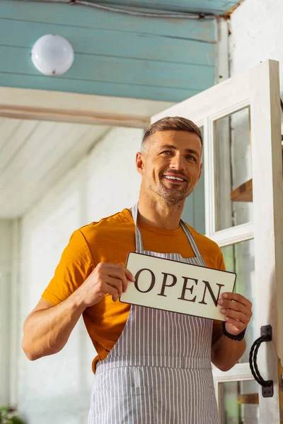 Happy smiling man opening his new shop. — Stock Photo, Image