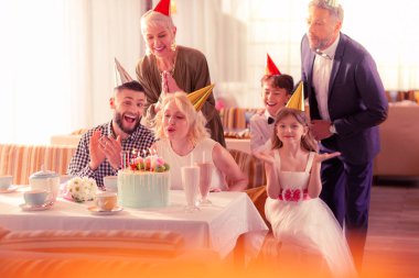 Woman celebrating birthday with husband and family clipart