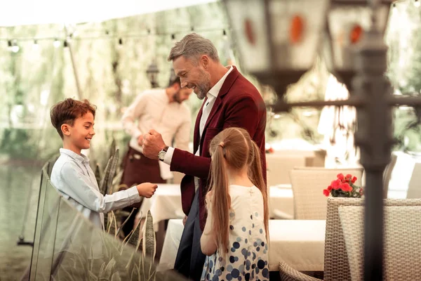 Handsome little son feeling happy meeting his father for lunch — Stock Photo, Image