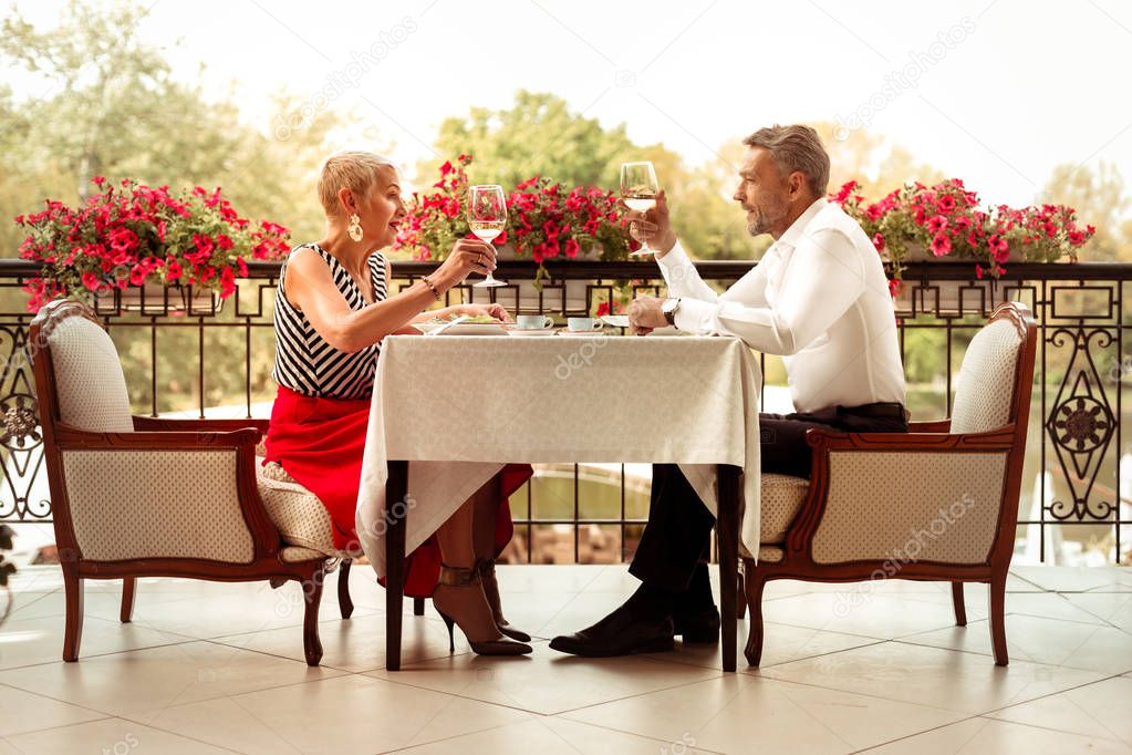 Businessmen sitting on balcony and enjoying romantic dinner